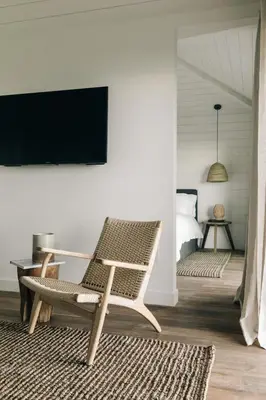 a room with a chair and a tv on a wall at The Surfrider Malibu in Malibu