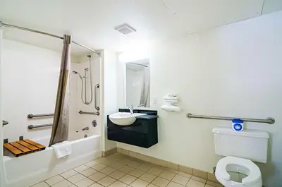 a bathroom with a toilet and a sink and a shower at Motel 6-Barstow, CA in Barstow