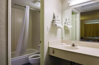 a bathroom with a sink and a toilet and a mirror at Motel 6-Barstow, CA in Barstow