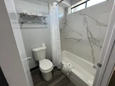 a bathroom with a toilet and a bath tub at Studio 6 Bakersfield, CA South in Bakersfield
