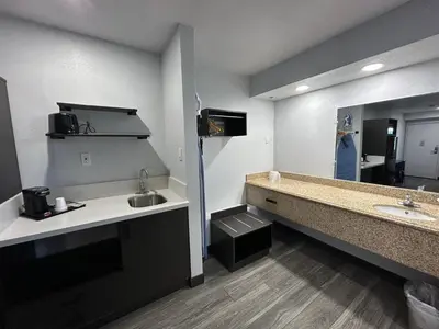 a bathroom with two sinks and a large mirror at Studio 6 Bakersfield, CA South in Bakersfield