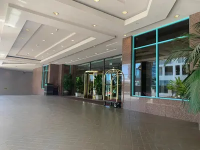 an empty lobby of a building with glass windows at Oxford Palace Hotel in Los Angeles