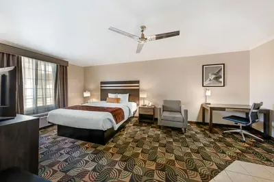 a hotel room with a bed and a desk at Best Western Plus Country Park Hotel in Tehachapi