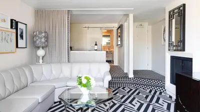 a living room with a white couch and a table at Chamberlain West Hollywood in Los Angeles