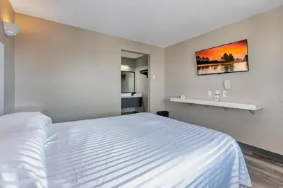a bedroom with a white bed in a room at Morada Inn in Anaheim