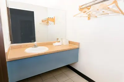 a bathroom with a sink and a mirror at Morada Inn in Anaheim