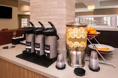 a counter with a bunch of wine bottles on a counter at TownePlace Suites by Marriott San Bernardino Loma Linda in Loma Linda