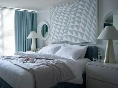a bedroom with a large white bed and a window at Avalon Hotel Beverly Hills, a Member of Design Hotels in Los Angeles