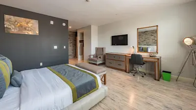 a bedroom with a bed and a desk with a computer at Lexen Hotel - North Hollywood Near Universal Studios in North Hollywood