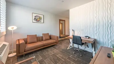 a living room with a couch and a desk at Lexen Hotel - North Hollywood Near Universal Studios in North Hollywood
