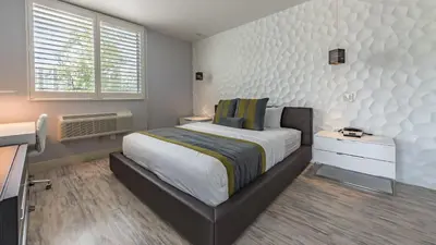 a bedroom with a large bed and a white wall at Lexen Hotel - North Hollywood Near Universal Studios in North Hollywood