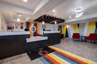 a lobby with a waiting room with colorful walls at Motel 6-Buttonwillow, CA Central in Buttonwillow