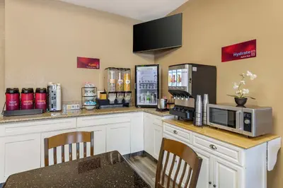 a kitchen with a counter with a microwave and a refrigerator at Best Western Plus Heritage Inn Ontario Rancho Cucamonga in Rancho Cucamonga
