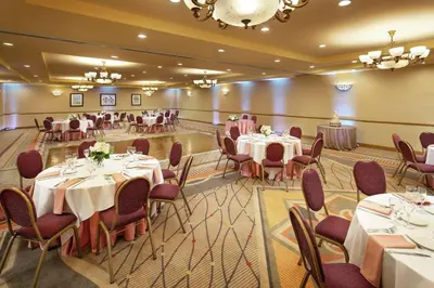 a banquet hall with tables and chairs in a room at DoubleTree by Hilton Claremont in Claremont