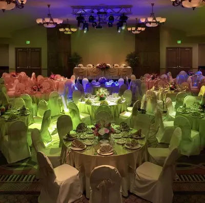 a room filled with tables and chairs with white tablecloths at DoubleTree by Hilton Claremont in Claremont