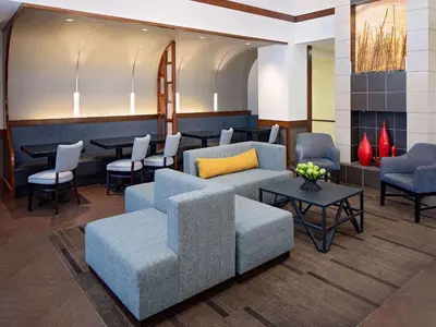 a lobby with chairs and tables and a waiting room at Hyatt Place Ontario/Rancho Cucamonga in Ontario