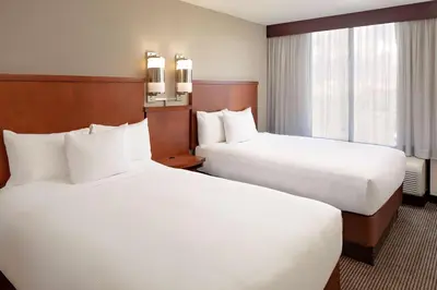 a hotel room with two beds and a window at Hyatt Place Ontario/Rancho Cucamonga in Ontario