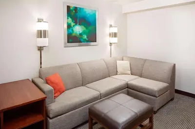 a living room with a couch and a table at Hyatt Place Ontario/Rancho Cucamonga in Ontario