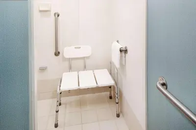 a white toilet in a bathroom with a seat at Hyatt Place Ontario/Rancho Cucamonga in Ontario