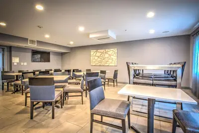 a restaurant with tables and chairs in a room at Best Western Plus Media Center Inn & Suites in Burbank