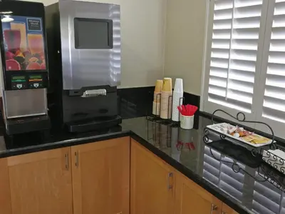 a kitchen with a counter top with a microwave at Burbank Inn and Suites in Burbank