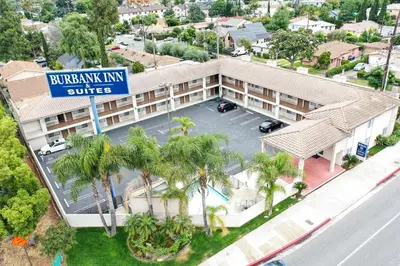 an overhead view of a hotel with a street sign and palm trees at Burbank Inn and Suites in Burbank