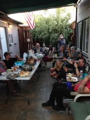 a group of people sitting at tables eating food at Timen House in North Hollywood