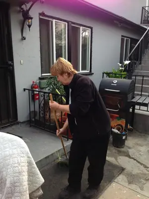 a boy holding a baseball bat in front of a house at Timen House in North Hollywood