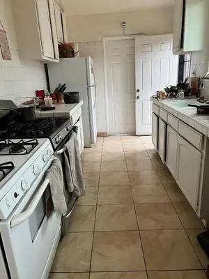 a kitchen with white appliances and a tile floor at Timen House in North Hollywood