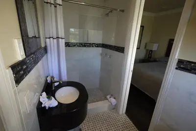 a bathroom with a toilet and a sink and a shower at Trylon Hotel - Hollywood in Los Angeles