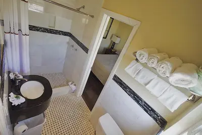 a bathroom with a shower and a toilet and a mirror at Trylon Hotel - Hollywood in Los Angeles