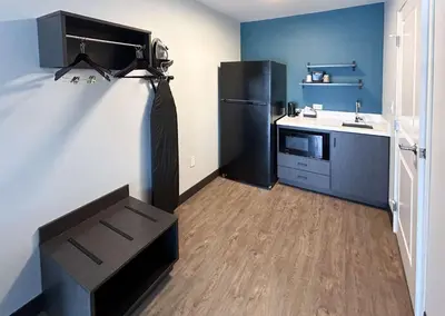 a kitchen with a black refrigerator and a sink at Studio 6 Corona, CA West in Corona