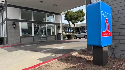 a blue mail box sitting in front of a building at Studio 6 Corona, CA West in Corona