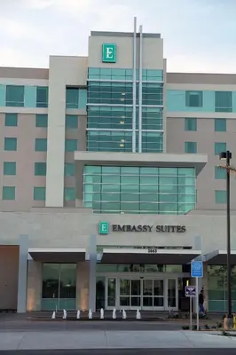 a large office building with an emergency shuttle at Embassy Suites Ontario - Airport in Ontario