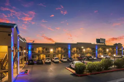 a hotel with cars parked in a parking lot at Econo Lodge Hesperia - Victorville I-15 in Hesperia