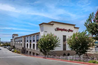 a building with a sign on the side of it at Hampton Inn Norco/Corona in Norco