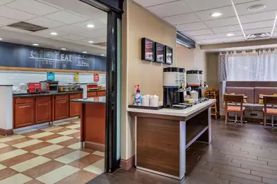 a fast food restaurant with a counter and a kitchen at Hampton Inn Norco/Corona in Norco