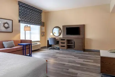 a hotel room with a bed and a flat screen tv at Hampton Inn Norco/Corona in Norco