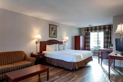 a hotel room with a bed and a couch at Studio City Court Yard Hotel in Los Angeles