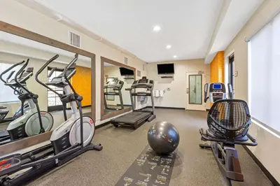 a gym with treadmills and ellipticals in a room at La Quinta by Wyndham NE Long Beach/Cypress in Hawaiian Gardens