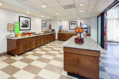 a large room with a cafeteria with a checkerboard floor at Hampton Inn & Suites Chino Hills in Chino Hills