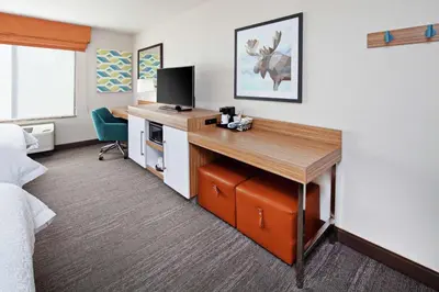 a hotel room with a desk with a television at Hampton Inn & Suites Chino Hills in Chino Hills