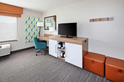 a room with a desk with a television and a chair at Hampton Inn & Suites Chino Hills in Chino Hills
