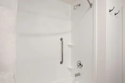 a white bathroom with a shower and a sink at Hampton Inn & Suites Chino Hills in Chino Hills