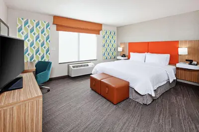 a hotel room with a bed and a flat screen tv at Hampton Inn & Suites Chino Hills in Chino Hills