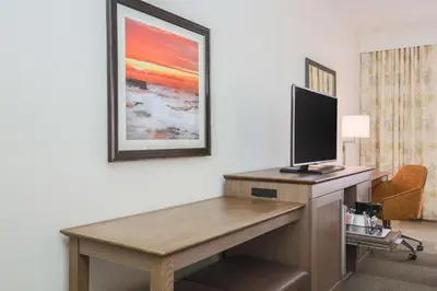 a hotel room with a desk with a flat screen tv at Hampton Inn & Suites Camarillo in Camarillo