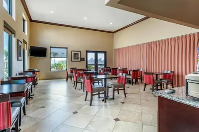 a dining room with tables and chairs at Comfort Inn & Suites Colton - San Bernardino in Colton