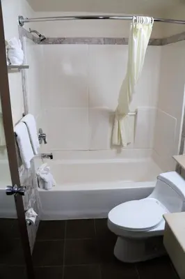 a bathroom with a white tub and a toilet at California Inn Barstow in Barstow