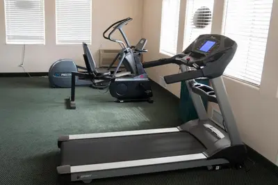 a gym with two exercise bikes and a treadmill at California Inn Barstow in Barstow