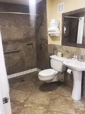 a bathroom with a toilet and a sink and a shower at Super 8 by Wyndham Redlands/San Bernardino in Redlands